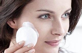 Žena nanosi Mleko za čišćenje na tupfer